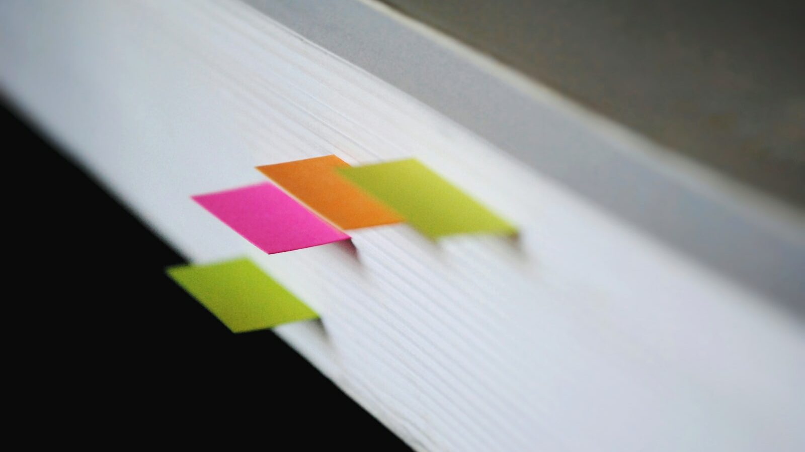 shallow focus photography of green, pink, and orange bookmarks